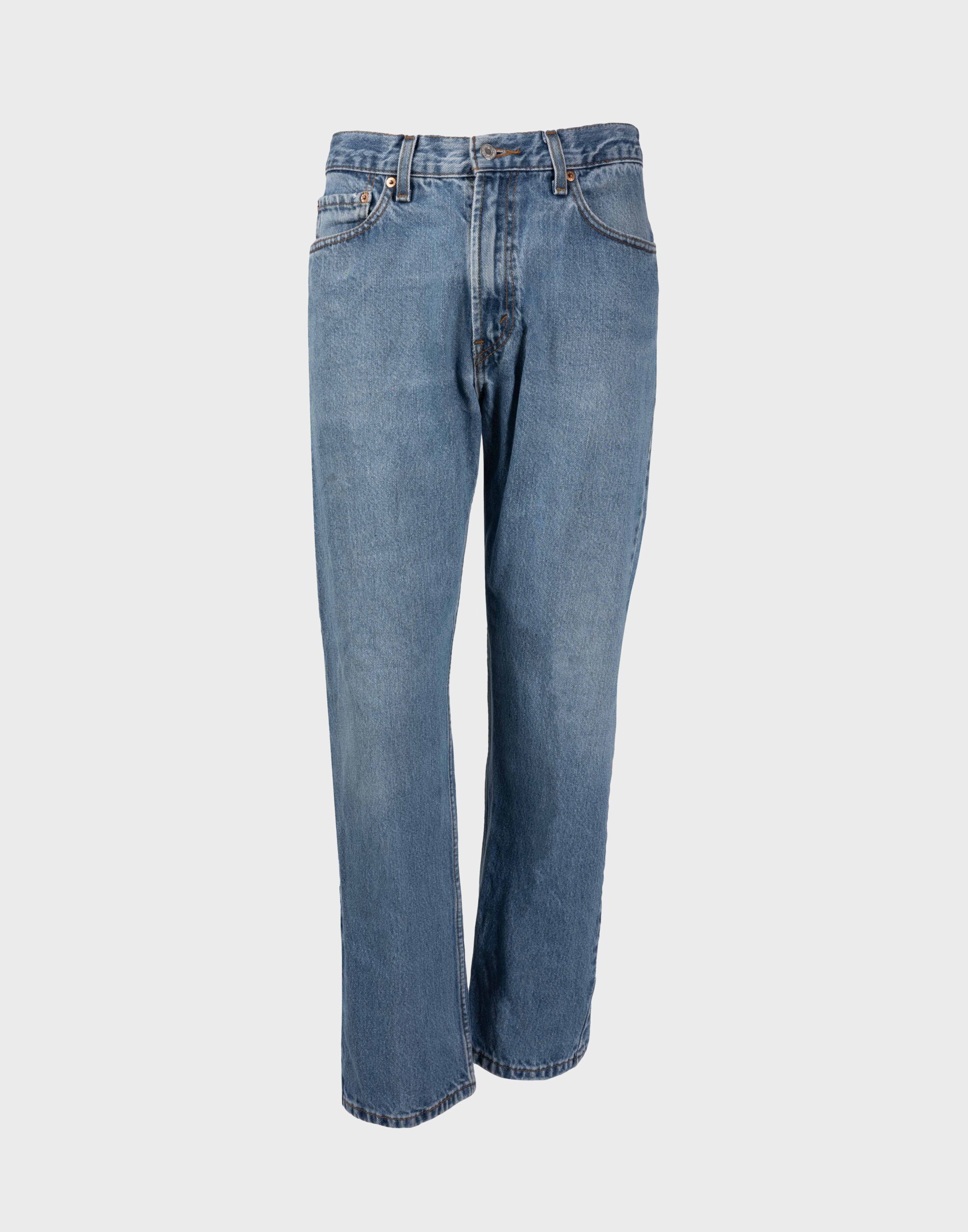 medium wash denim jeans photographed on a ghost mannequin with a gray background