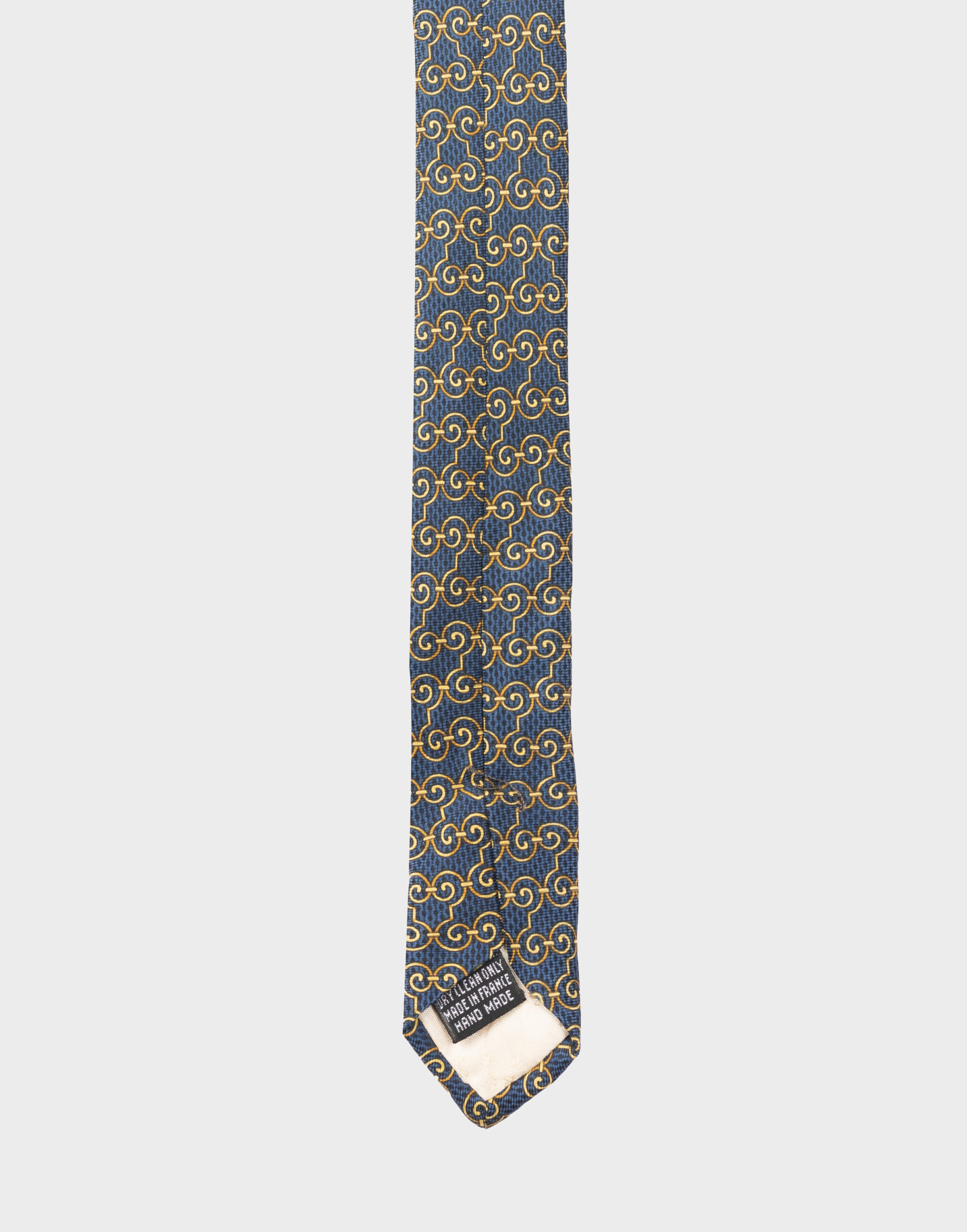blue silk tie with gold geometric pattern