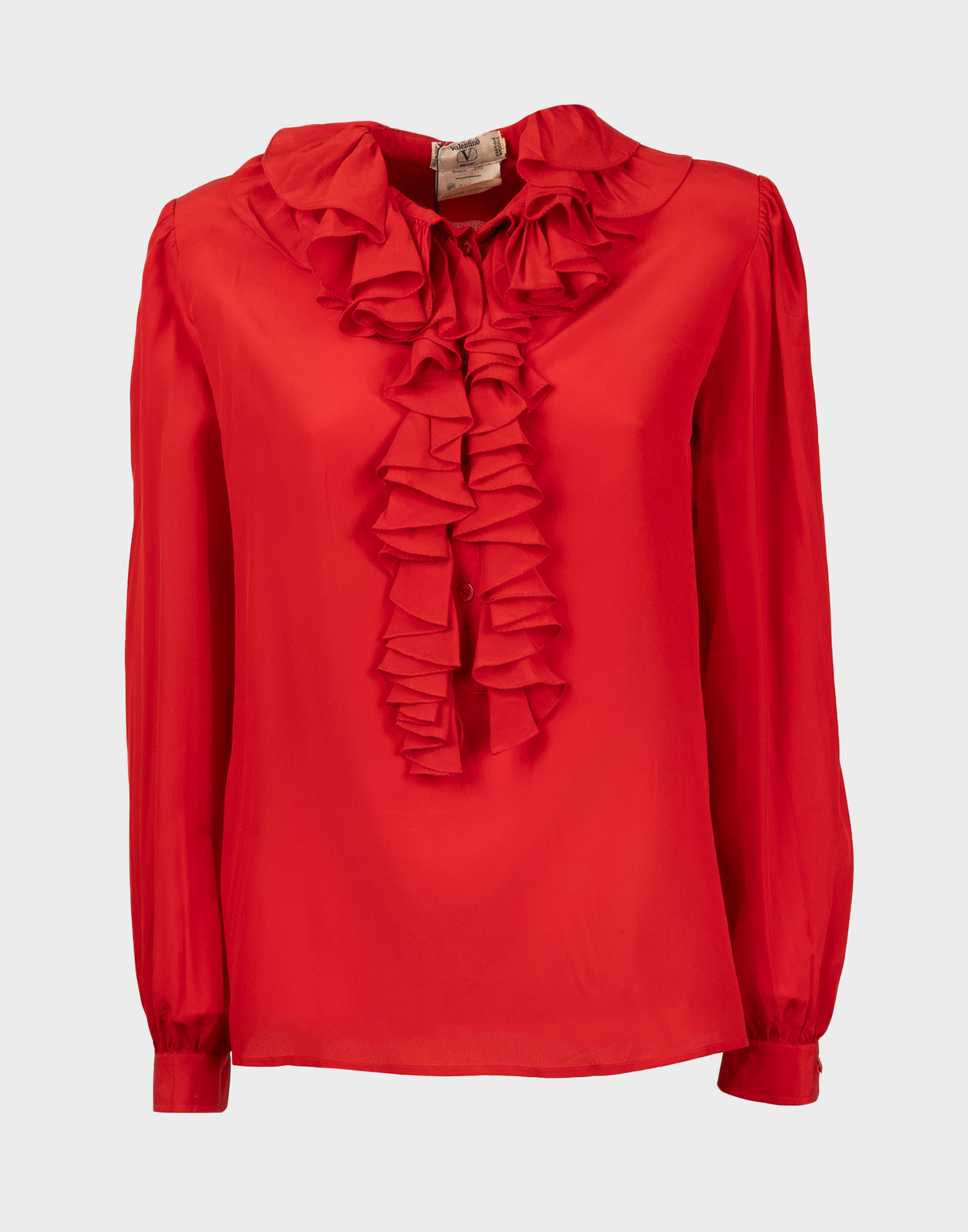 Red silk women's blouse with long sleeves, ruffled collar and front detailing, and padded shoulders.