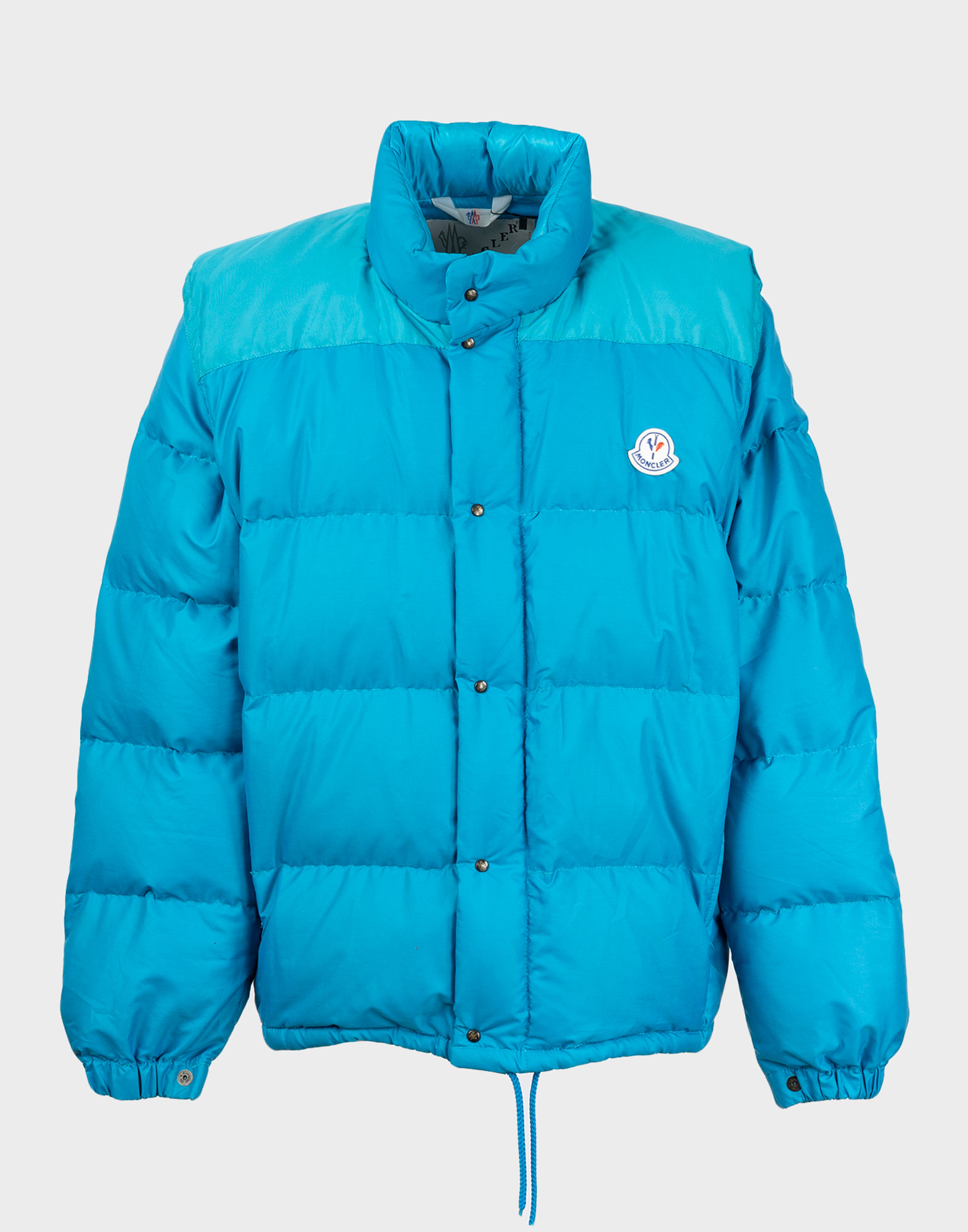 Light blue men's moncler down jacket with removable sleeves, front clip-on button closure, drawstring waist.