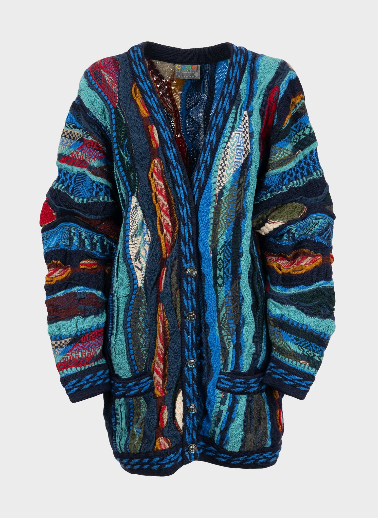 blue women's cardigan in multicolor patterned signed coogi, deep v-neck, two front pockets