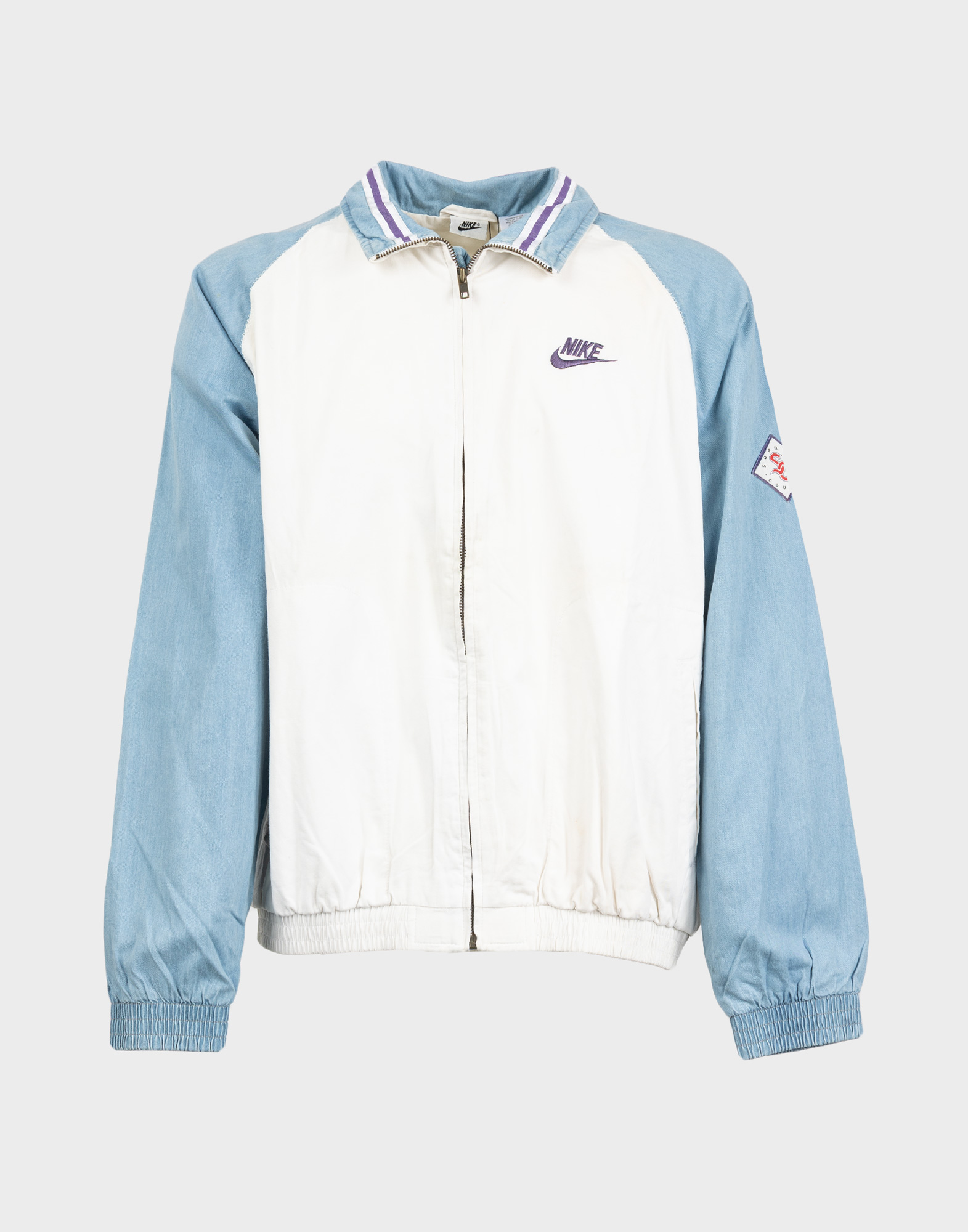 giacca tuta nike bianca anni 90 con maniche celesti, chiusura anteriore con cerniera